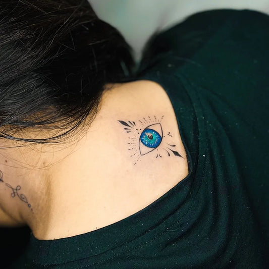 Small Dotwork Evil Eye on Women Shoulder Tattoo by @riseinktattoo_and_nailart