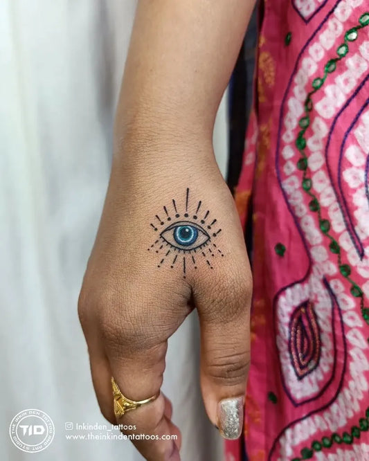 Small Dotwork Evil Eye with Rays on Women Hand Tattoo by @inkinden_tattoos