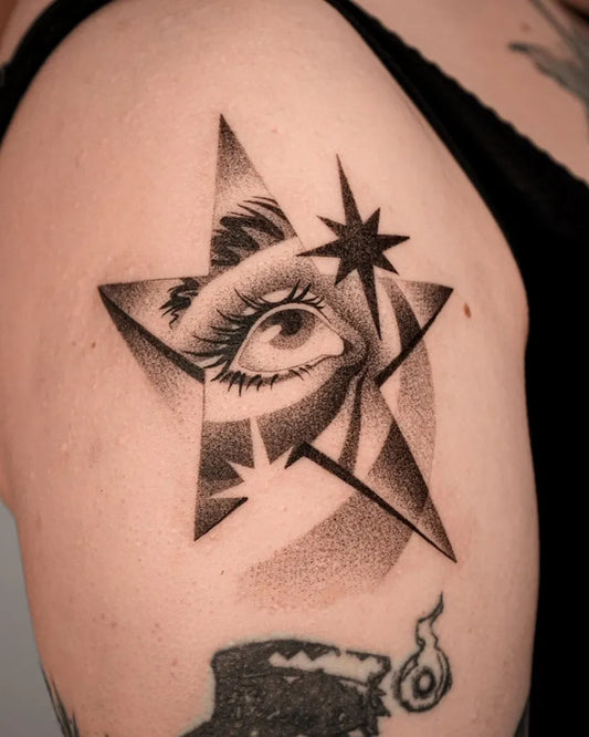 Small Dotwork Eye in Star Tattoo on Women Shoulder by @duzo.kropek.malo.kresek