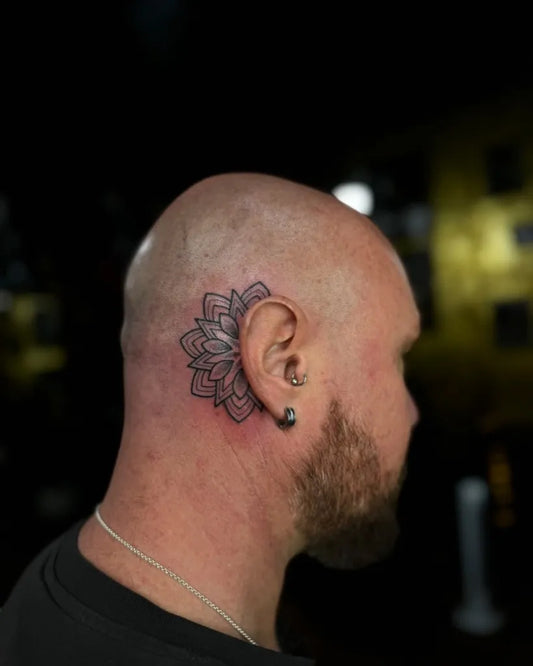 Small Dotwork Lotus Tattoo on Men Behind the Ear by @ashleesnowtattoo