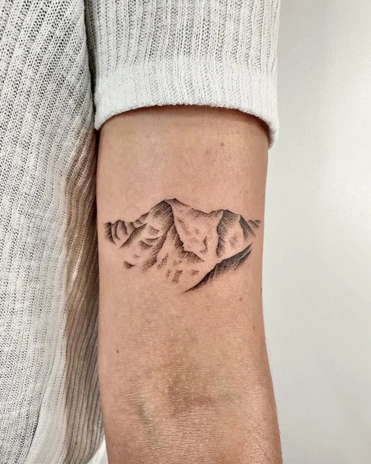 Small Dotwork Mountain Tattoo on Women Arm by @louka.tattooist