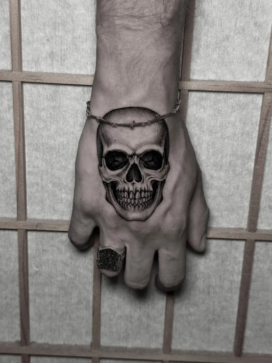 Small Dotwork Skull Tattoo on Men Hand by @martinovic.tattoo