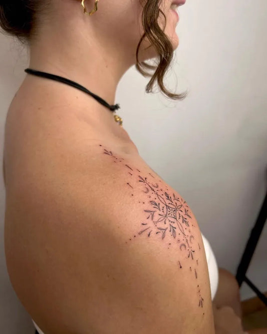 Small Dotwork Snowflake Tattoo on Women Shoulder by @malaika_tattoo