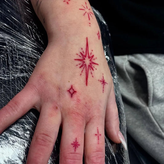 Small Dotwork Star Cluster on Women Hand Tattoo by @liquorice_ink