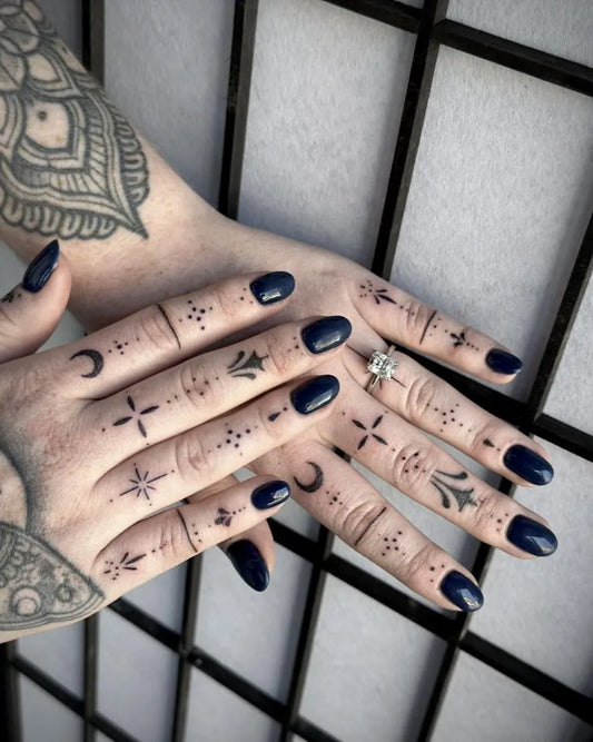 Small Dotwork Stars Moons on Women Fingers Tattoo by @obsidian_ink_taunton