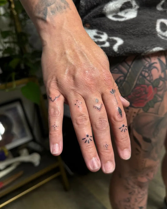 Small Dotwork StarsDotsCross on Women Fingers Tattoo by @ink_by_brina