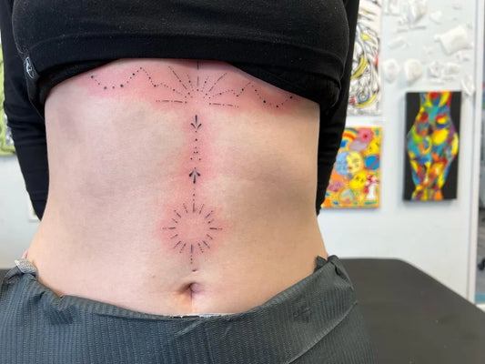 Small Dotwork Sun and Dots on Women Sternum Tattoo by @ggmtats