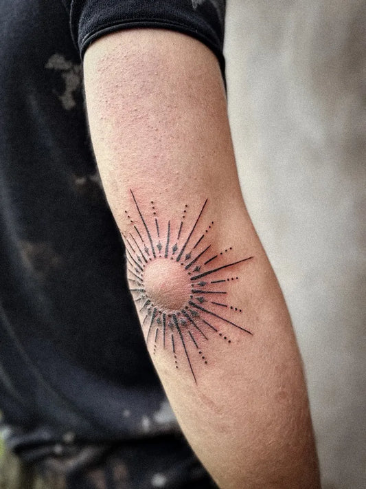 Small Dotwork Sun on Men Elbow Tattoo by @matahari.tattoo
