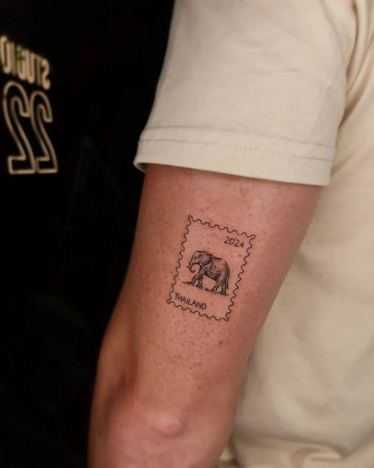 Small Elephant Stamp Tattoo on Men Arm by @studio22_tattoo