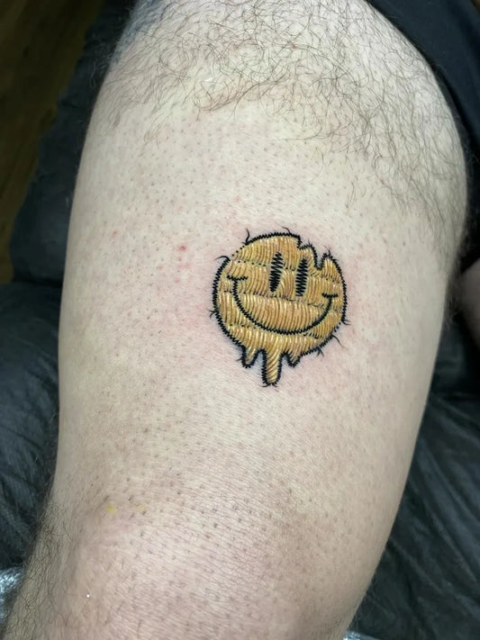 Small Embroidery Dripping Smiley Face Tattoo on Men Arm by @barbaroscicek