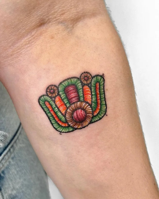 Small Embroidery Floral Crown Tattoo on Women Forearm by @gungho_tattoo_studio