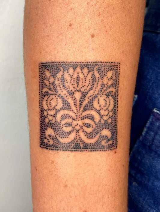 Small Embroidery Floral Square Tattoo on Women Arm by @shell_station_tattoo