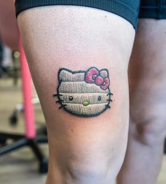 Small Embroidery Hello Kitty Tattoo on Women Thigh by @_loveinktattoos_