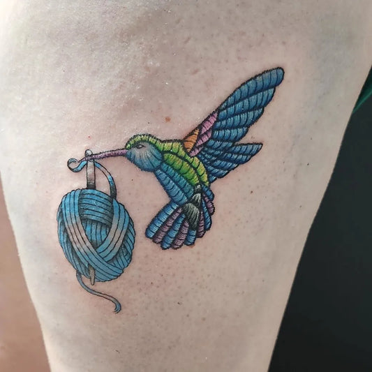 Small Embroidery Hummingbird and Yarn Tattoo on Women Thigh by @khaotikstrawbrry