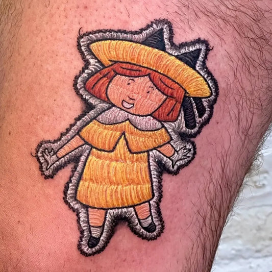 Small Embroidery Madeline Doll Tattoo on Men Leg by @crownandfeathertattoo