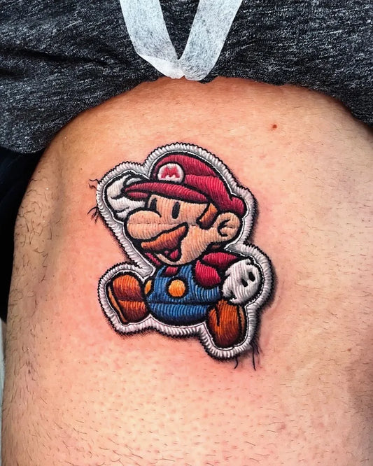 Small Embroidery Mario Tattoo on Men Thigh by @tatt