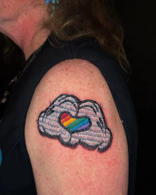 Small Embroidery Rainbow Heart in Cloud Tattoo on Women Arm by @missdtattoo