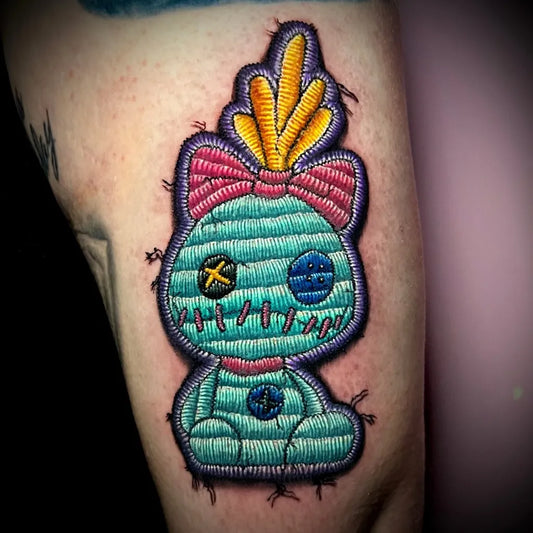 Small Embroidery Voodoo Doll Tattoo on Women Arm by @hazelstattoos