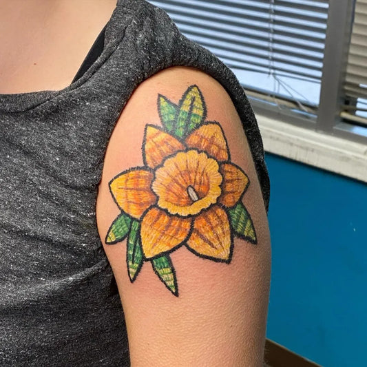 Small Embroidery Yellow Daffodil with Green Leaves Tattoo on Women Shoulder by @ellettart