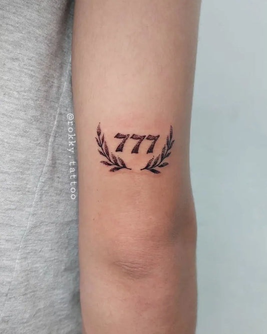 Small Fine Line 777 Laurel Tattoo on Women Forearm by @rokky.tattoo