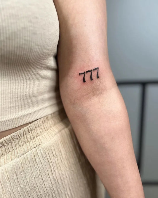 Small Fine Line 777 Tattoo on Women Arm by @ani_ka_tattoo