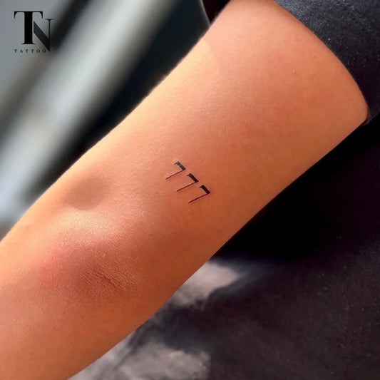Small Fine Line 777 Tattoo on Women Arm by @nazanin.tntattoo
