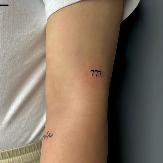 Small Fine Line 777 Tattoo on Women Arm by @pariatatt