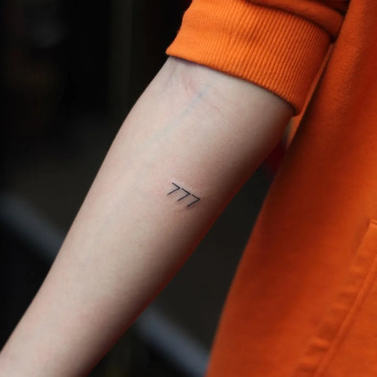 Small Fine Line 777 Tattoo on Women Arm by @psycho5701