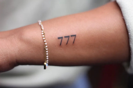 Small Fine Line 777 Tattoo on Women Forearm by @psycho5701