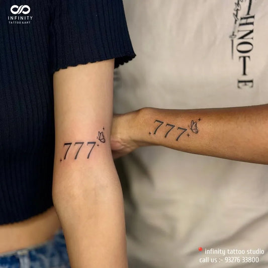 Small Fine Line 777 and Butterfly Tattoo on Women Arm by @infinity_tattoondart