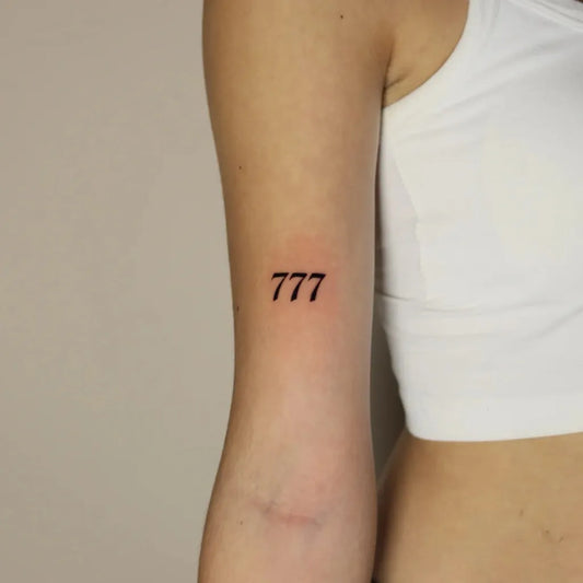 Small Fine Line Angel Number 777 Tattoo on Women Arm by @romeotattoost