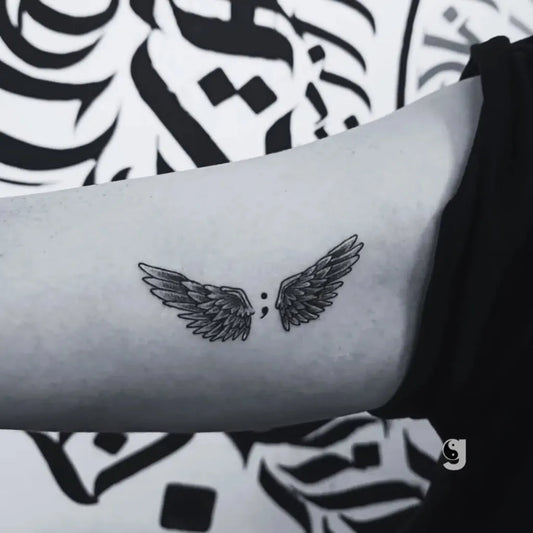 Small Fine Line Angel Wings Tattoo on Women Upper Arm by @galaxytattoobekasi