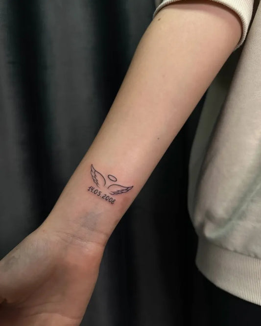 Small Fine Line Angel Wings and Halo Tattoo on Women Wrist by @bo_na_tattoo.buchach
