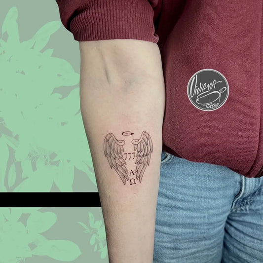 Small Fine Line Angel Wings with 777 Tattoo on Women Arm by @vivianasp.tattoo