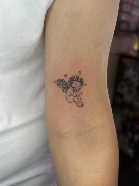 Small Fine Line Angel with Hearts on Women Arm Tattoo by @yanninkstattoo