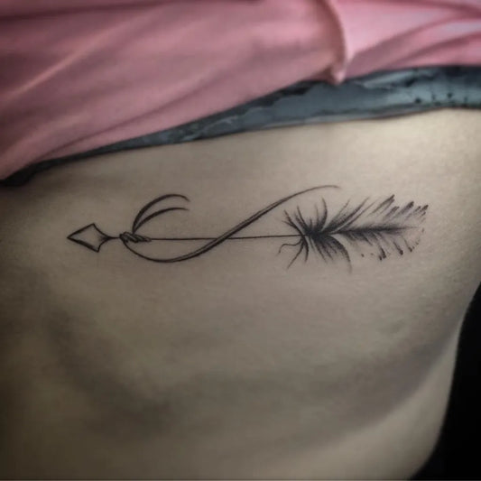 Small Fine Line Arrow and Infinity Tattoo on Women Rib by @babyjoemoon