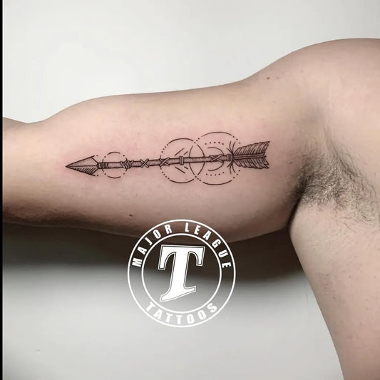 Small Fine Line Arrow with Circles Tattoo on Men Upper Arm by @majorleaguetattoos