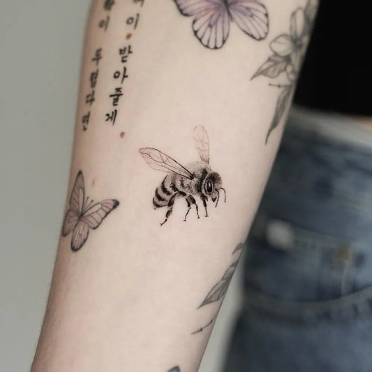 Small Fine Line Bee Butterfly Flowers on Women Arm Tattoo by @ttt_crong