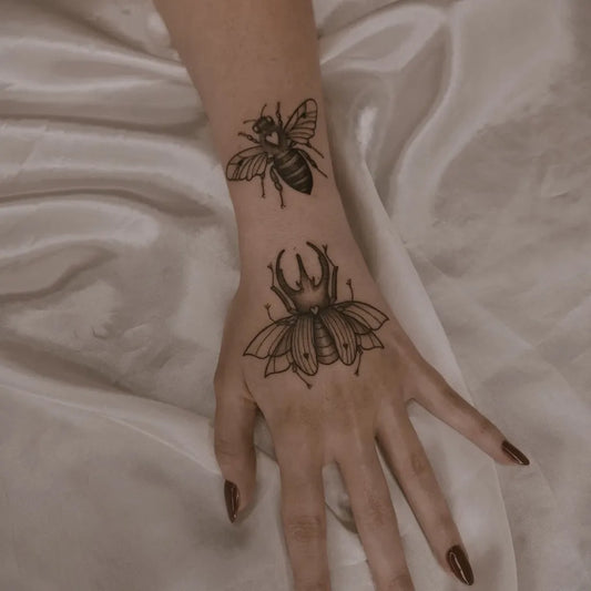 Small Fine Line Bee and Beetle on Women Wrist Tattoo by @vi.marcondestattoo