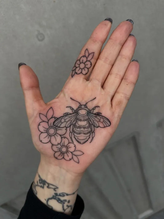 Small Fine Line Bee and Flowers on Women Hand Tattoo by @lukeaashley