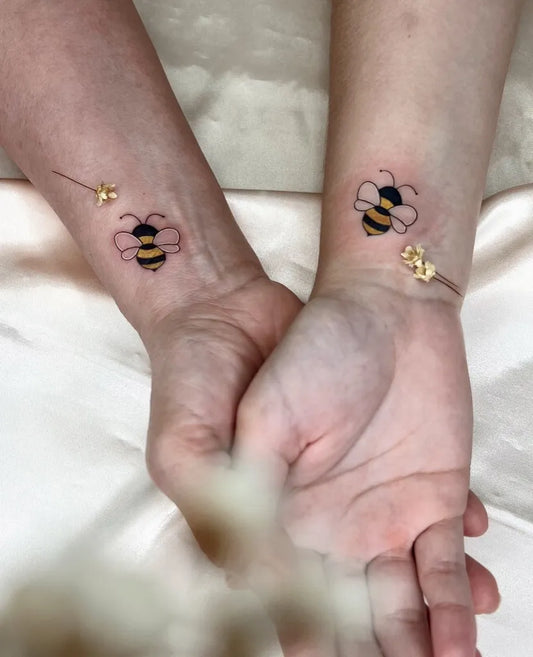 Small Fine Line Bee and Flowers on Women Wrist Tattoo by @abrunatattoo