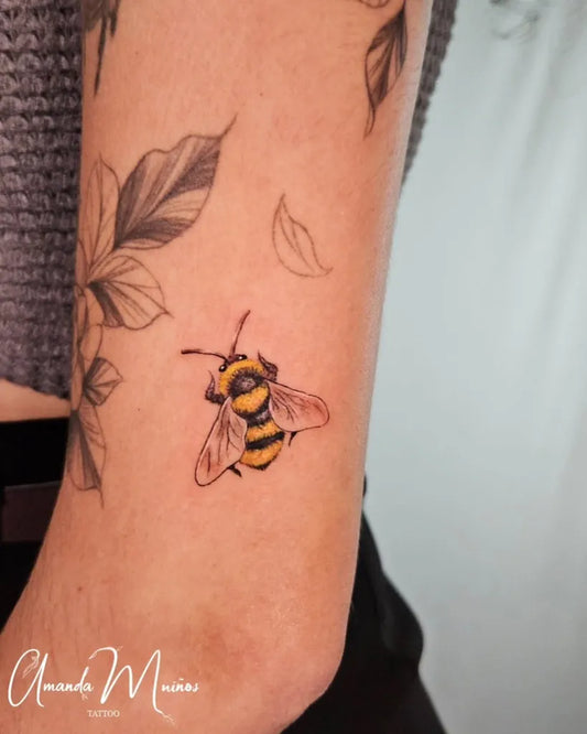 Small Fine Line Bee and Leaves on Women Arm Tattoo by @amandamuinos
