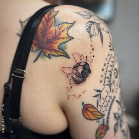 Small Fine Line Bee and Maple Leaf on Women Shoulder Tattoo by @koritattoos