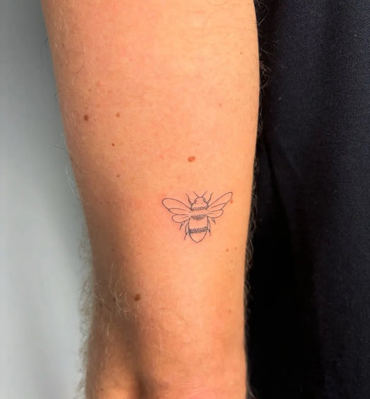 Small Fine Line Bee on Women Arm Tattoo by @elle.tats