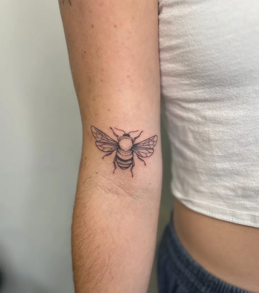 Small Fine Line Bee on Women Arm Tattoo by @seed.eternal