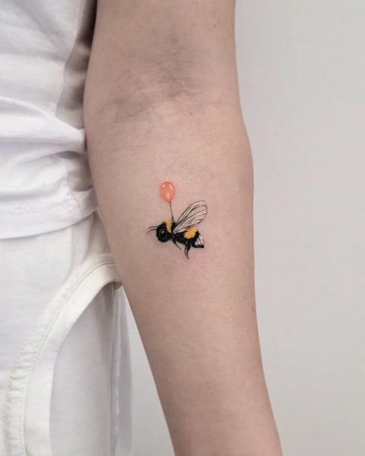 Small Fine Line Bee with Balloon on Women Arm Tattoo by @vogli.tattoo