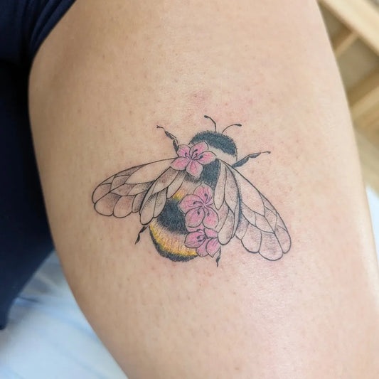 Small Fine Line Bee with Flowers on Women Thigh Tattoo by @miray.tattoo