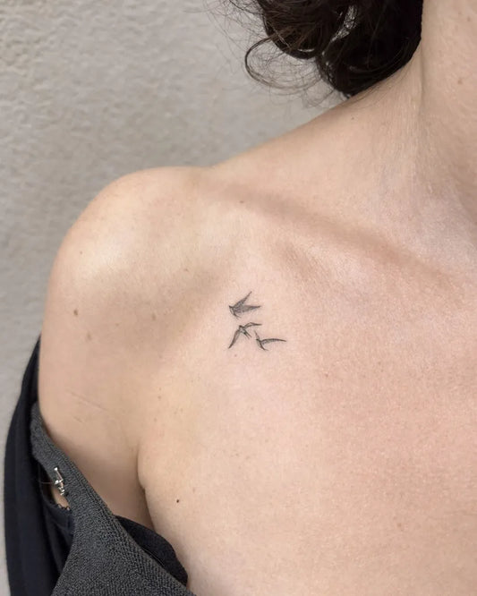 Small Fine Line Bird Tattoo on Women Collarbone by @vladkork