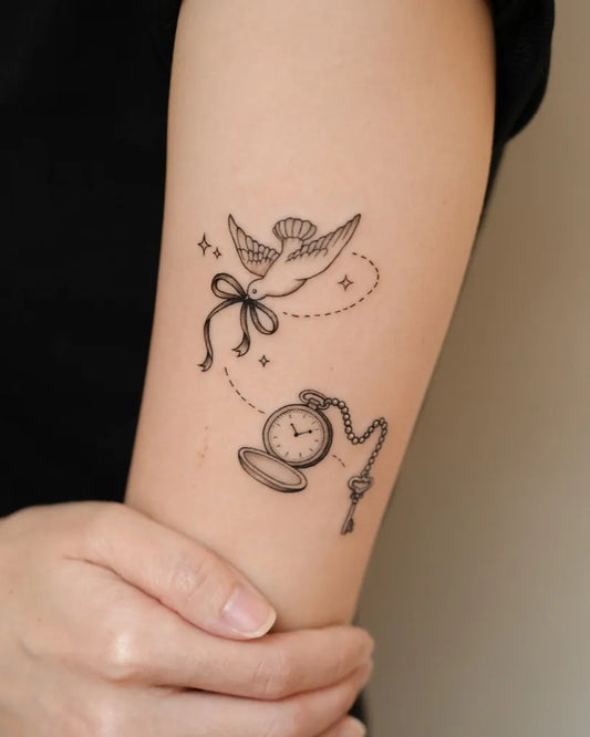 Small Fine Line Bird and Pocket Watch Tattoo on Women Arm by @tattooist_yun