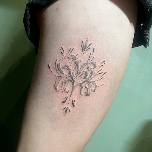 Small Fine Line Black Spider Lily Tattoo on Women Thigh by @chloe.tatts